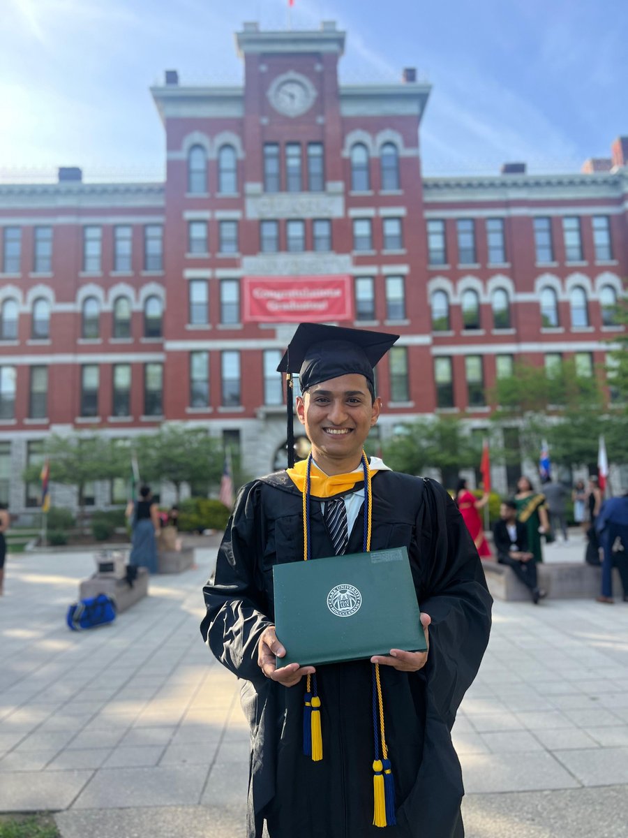 Nachiket at Clark University 2024 graduation, holding MS Marketing Analytics diploma with Beta Gamma Sigma honor cords